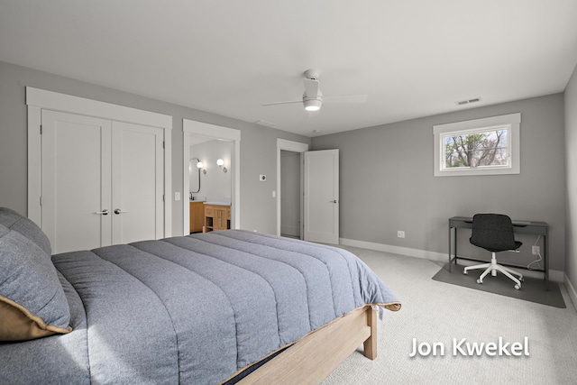 carpeted bedroom featuring visible vents, baseboards, a closet, ceiling fan, and connected bathroom