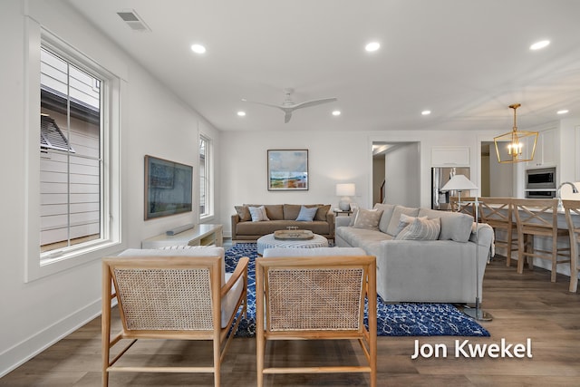living area featuring plenty of natural light, wood finished floors, visible vents, and recessed lighting