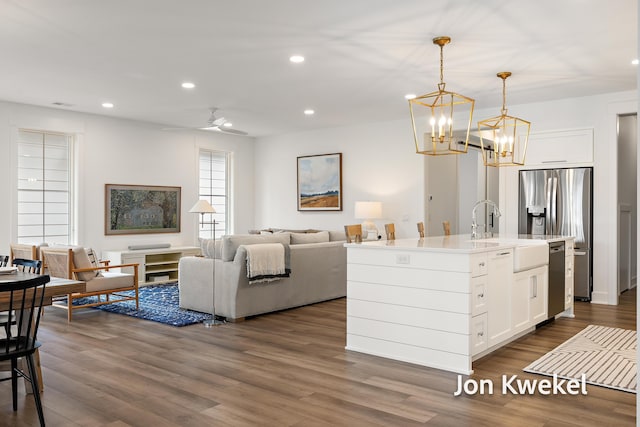 kitchen featuring dark wood-style flooring, white cabinetry, and recessed lighting