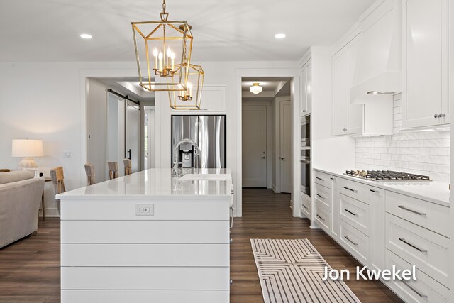 kitchen with tasteful backsplash, dark wood-style floors, white cabinetry, and appliances with stainless steel finishes