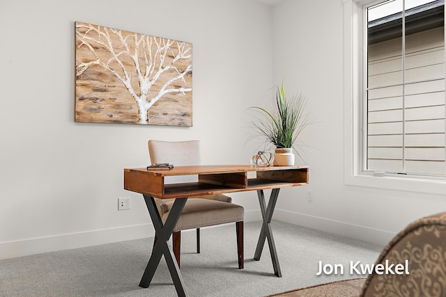 carpeted office space featuring baseboards