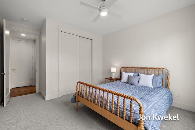 bedroom featuring carpet, a closet, baseboards, and a ceiling fan