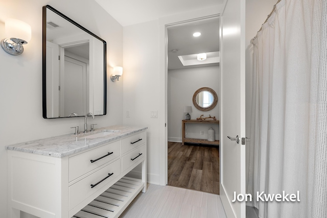 full bath featuring visible vents, baseboards, vanity, and a skylight