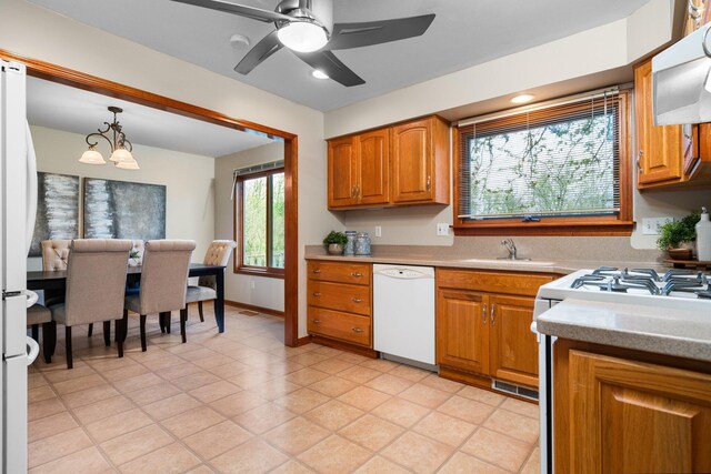 1569 Sheffield Dr, Ypsilanti, MI 48198 - kitchen with white appliances, extractor fan, brown cabinetry, light countertops, and a sink