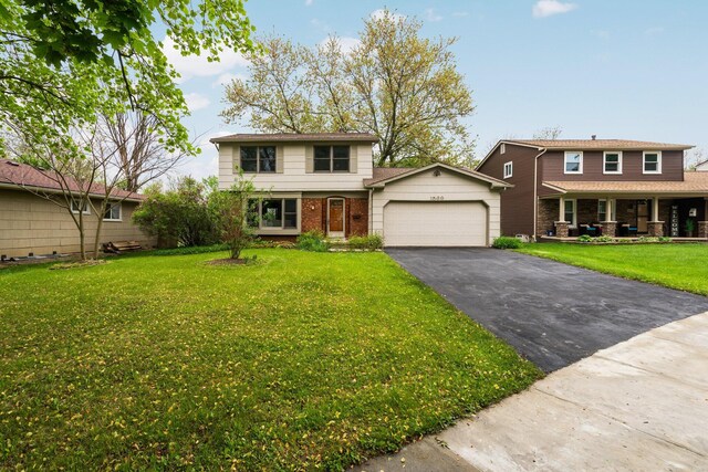 1569 Sheffield Dr, Ypsilanti, MI 48198 - view of front of property with asphalt driveway, an attached garage, brick siding, a front yard, and a porch