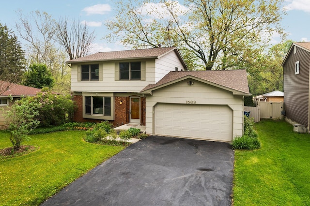 1569 Sheffield Dr, Ypsilanti, MI 48198 - view of front of home featuring an attached garage, asphalt driveway, brick siding, and roof with shingles
