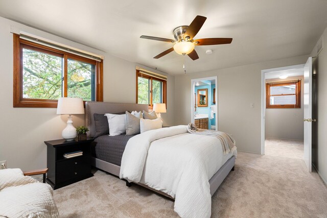 1569 Sheffield Dr, Ypsilanti, MI 48198 - bedroom with ensuite bathroom, light colored carpet, and a ceiling fan