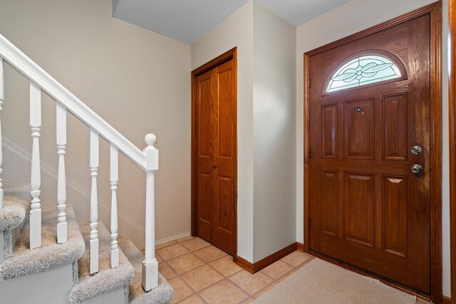 1569 Sheffield Dr, Ypsilanti, MI 48198 - entryway featuring baseboards, stairway, and light tile patterned floors
