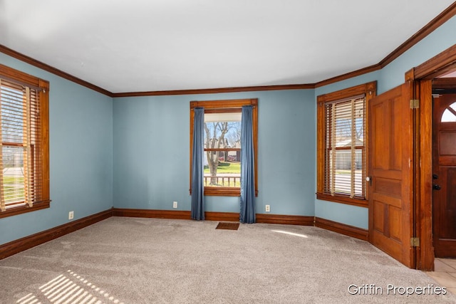 spare room with carpet flooring, baseboards, and ornamental molding