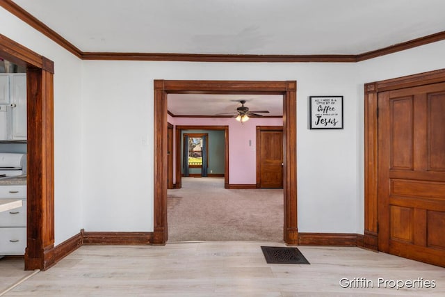 interior space featuring crown molding, visible vents, and baseboards