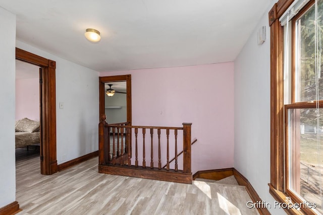 bonus room featuring plenty of natural light, baseboards, and wood finished floors