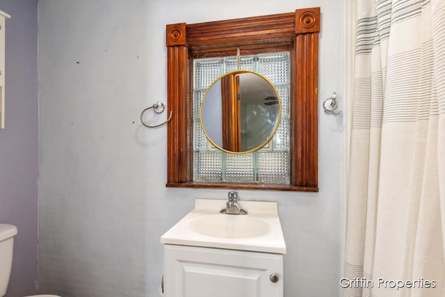 bathroom featuring vanity and toilet