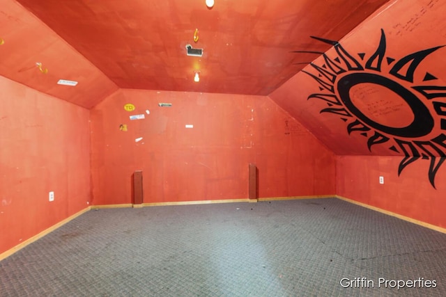 bonus room with baseboards, vaulted ceiling, and carpet floors