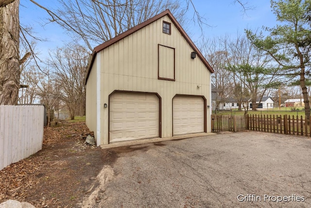 garage featuring a garage and fence