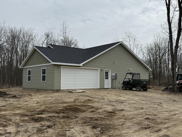 4745 Keith Rd, Hillsdale, MI 49242 - view of side of property with a shingled roof and a garage
