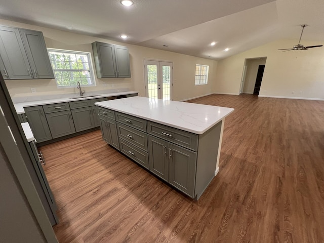 4745 Keith Rd, Hillsdale, MI 49242 - kitchen featuring french doors, gray cabinetry, a sink, a kitchen island, and vaulted ceiling