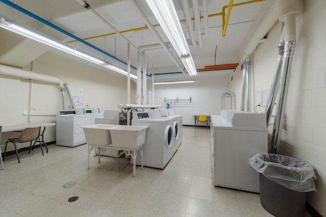 common laundry area featuring separate washer and dryer and light floors