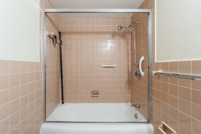 bathroom featuring bath / shower combo with glass door