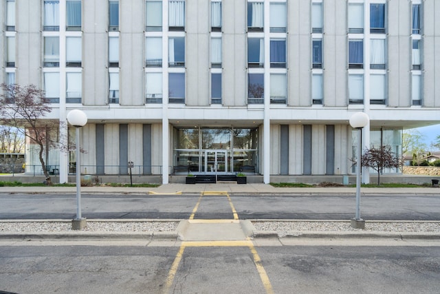 view of building exterior featuring uncovered parking