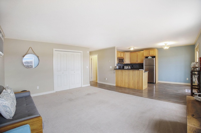 15330 Krueger St Unit 19, Spring Lake, MI 49456 - unfurnished living room with wood finished floors, baseboards, ornamental molding, and carpet floors