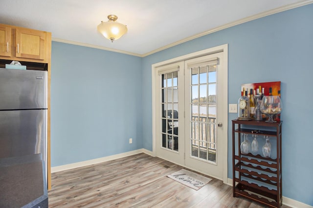15330 Krueger St Unit 19, Spring Lake, MI 49456 - interior space featuring french doors, ornamental molding, baseboards, and light wood finished floors
