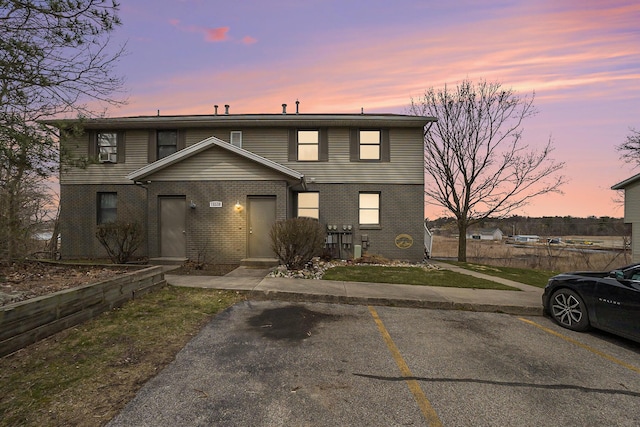 15330 Krueger St Unit 19, Spring Lake, MI 49456 - view of front facade featuring brick siding and uncovered parking