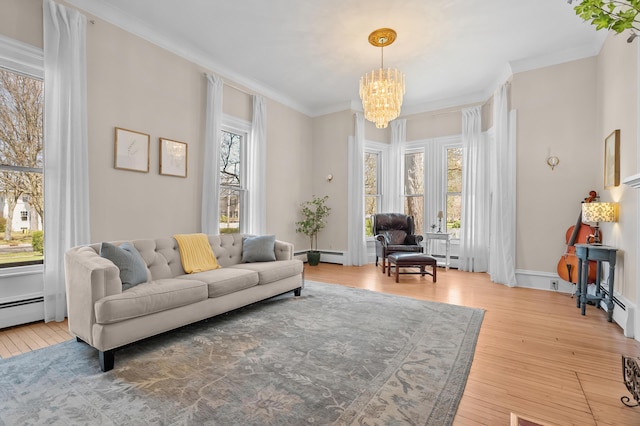 551 W Bridge St, Plainwell, MI 49080 - sitting room featuring a notable chandelier, a baseboard radiator, hardwood / wood-style floors, and crown molding