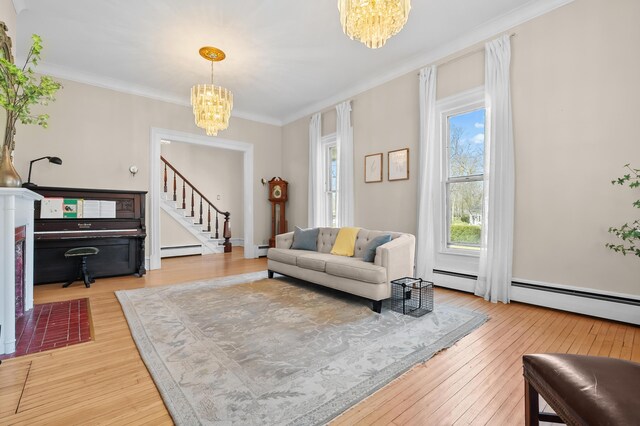 551 W Bridge St, Plainwell, MI 49080 - living area with a chandelier, hardwood / wood-style floors, a baseboard radiator, and stairs