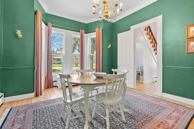 551 W Bridge St, Plainwell, MI 49080 - dining space featuring a notable chandelier, crown molding, stairs, hardwood / wood-style floors, and a baseboard radiator