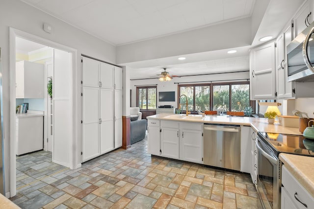 551 W Bridge St, Plainwell, MI 49080 - kitchen featuring recessed lighting, open floor plan, white cabinetry, appliances with stainless steel finishes, and a sink