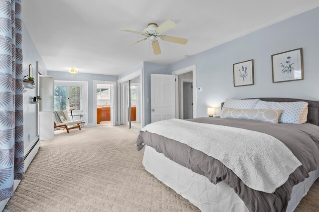 551 W Bridge St, Plainwell, MI 49080 - carpeted bedroom with a baseboard radiator, baseboards, connected bathroom, and ceiling fan