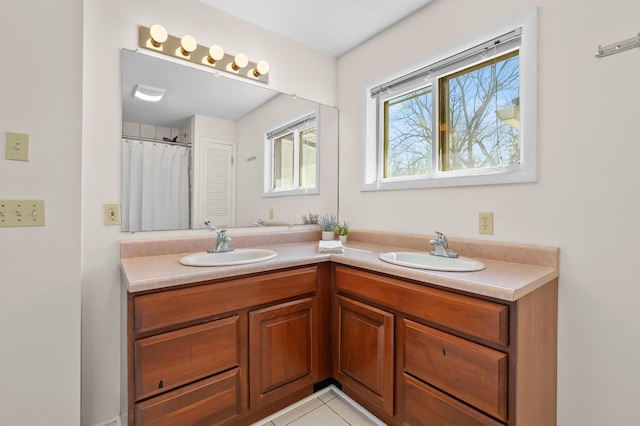 551 W Bridge St, Plainwell, MI 49080 - bathroom with a sink, visible vents, tile patterned floors, and double vanity