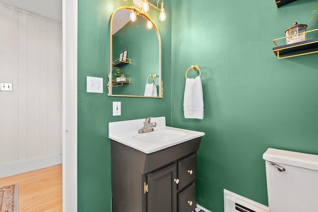551 W Bridge St, Plainwell, MI 49080 - half bathroom featuring toilet, vanity, and wood finished floors