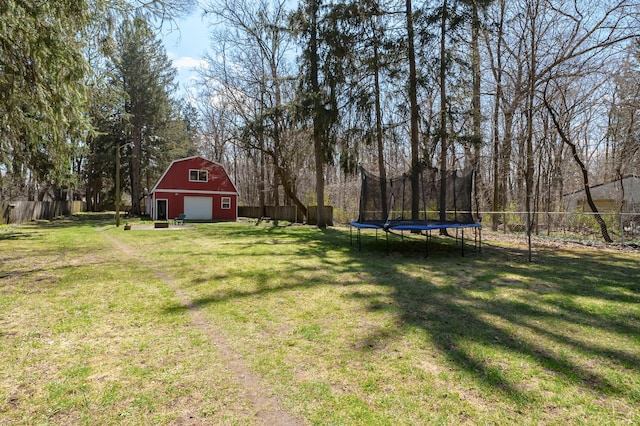 551 W Bridge St, Plainwell, MI 49080 - view of yard with a barn, a trampoline, a garage, and fence
