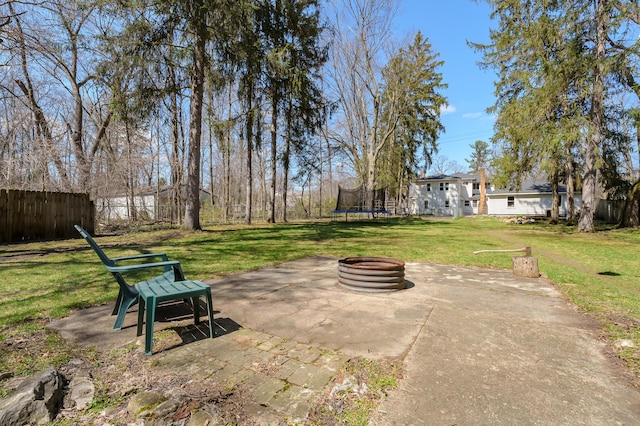 551 W Bridge St, Plainwell, MI 49080 - view of patio / terrace featuring an outdoor fire pit, a trampoline, and fence