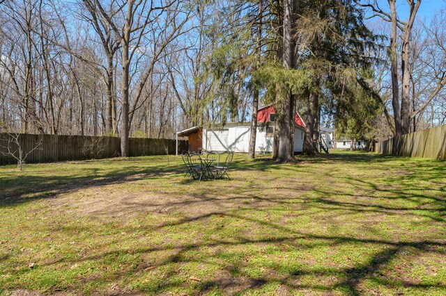 551 W Bridge St, Plainwell, MI 49080 - view of yard with a barn, fence, an outbuilding, and a detached garage