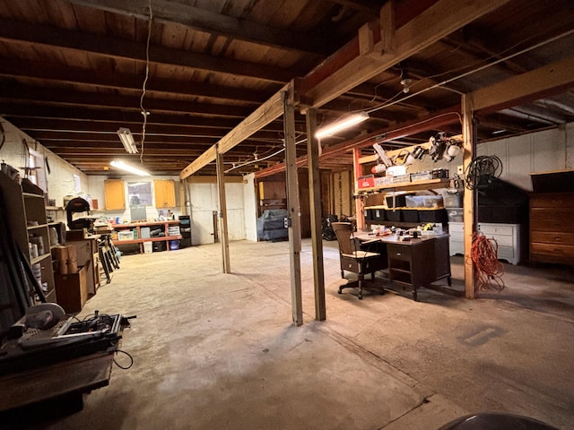 551 W Bridge St, Plainwell, MI 49080 - unfinished below grade area with a workshop area
