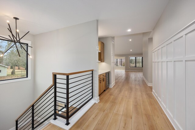 7701 Fase St SE Lot 15, Ada, MI 49301 - hallway with a notable chandelier, light wood-style flooring, recessed lighting, baseboards, and an upstairs landing