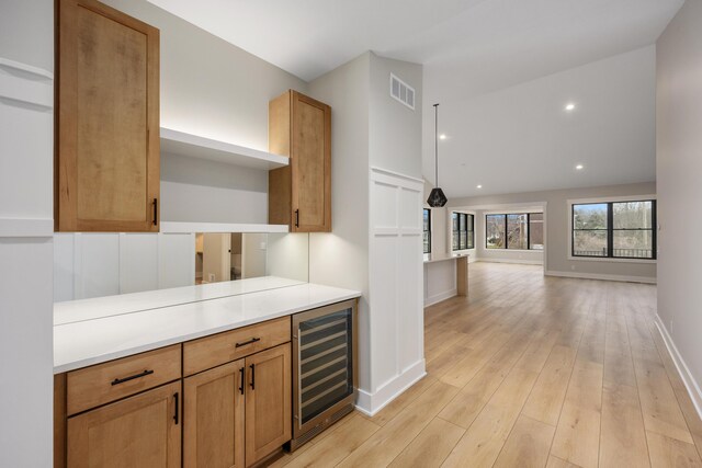 7701 Fase St SE Lot 15, Ada, MI 49301 - bar with wine cooler, baseboards, light wood-style floors, and visible vents
