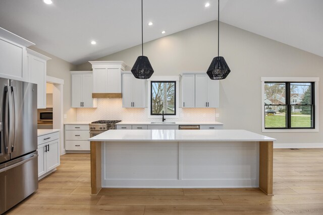 7701 Fase St SE Lot 15, Ada, MI 49301 - kitchen with a kitchen island, appliances with stainless steel finishes, a sink, light countertops, and recessed lighting