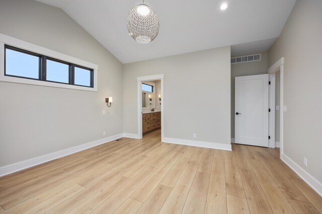 7701 Fase St SE Lot 15, Ada, MI 49301 - interior space with visible vents, a notable chandelier, baseboards, lofted ceiling, and light wood-style flooring