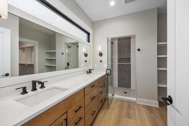 7701 Fase St SE Lot 15, Ada, MI 49301 - full bath featuring a sink, a walk in closet, a stall shower, and wood finished floors