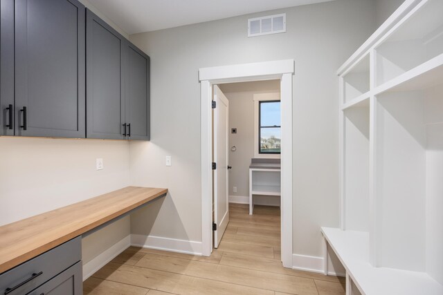 7701 Fase St SE Lot 15, Ada, MI 49301 - mudroom featuring baseboards, visible vents, built in study area, and light wood-type flooring