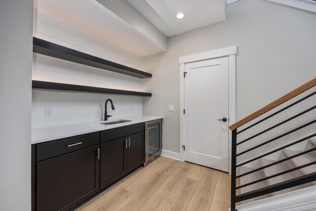 7701 Fase St SE Lot 15, Ada, MI 49301 - bar featuring a sink, indoor wet bar, light wood finished floors, beverage cooler, and stairs