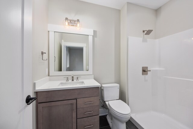 7701 Fase St SE Lot 15, Ada, MI 49301 - bathroom featuring vanity, toilet, and a shower