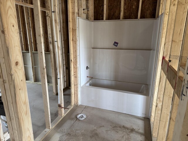 7701 Fase St SE Lot 15, Ada, MI 49301 - bathroom featuring unfinished concrete flooring and a bath