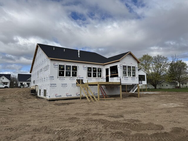 7701 Fase St SE Lot 15, Ada, MI 49301 - back of house featuring a deck, a sunroom, and stairway