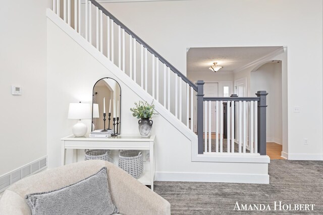 stairs with baseboards and visible vents