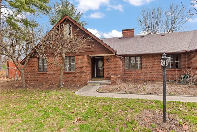 4675 Treat Hwy, Adrian, MI 49221 - view of front of house with brick siding, roof with shingles, a front lawn, and a chimney