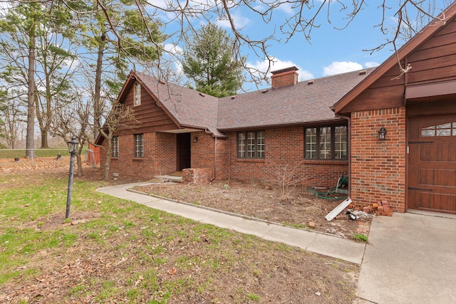 4675 Treat Hwy, Adrian, MI 49221 - ranch-style house featuring an attached garage, a chimney, brick siding, a front lawn, and roof with shingles